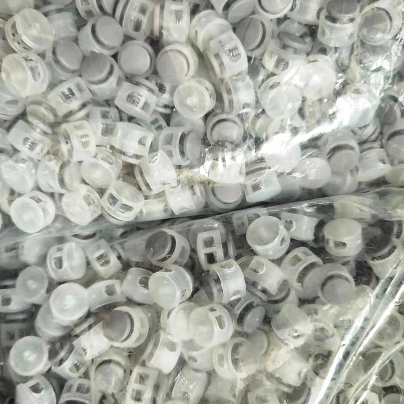 Assorted plastic cord locks with clear housings and metal springs