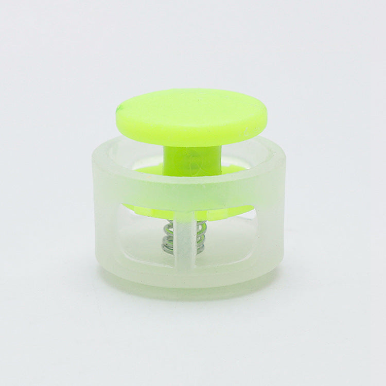 Plastic cord lock toggle with neon green round stopper in clear housing