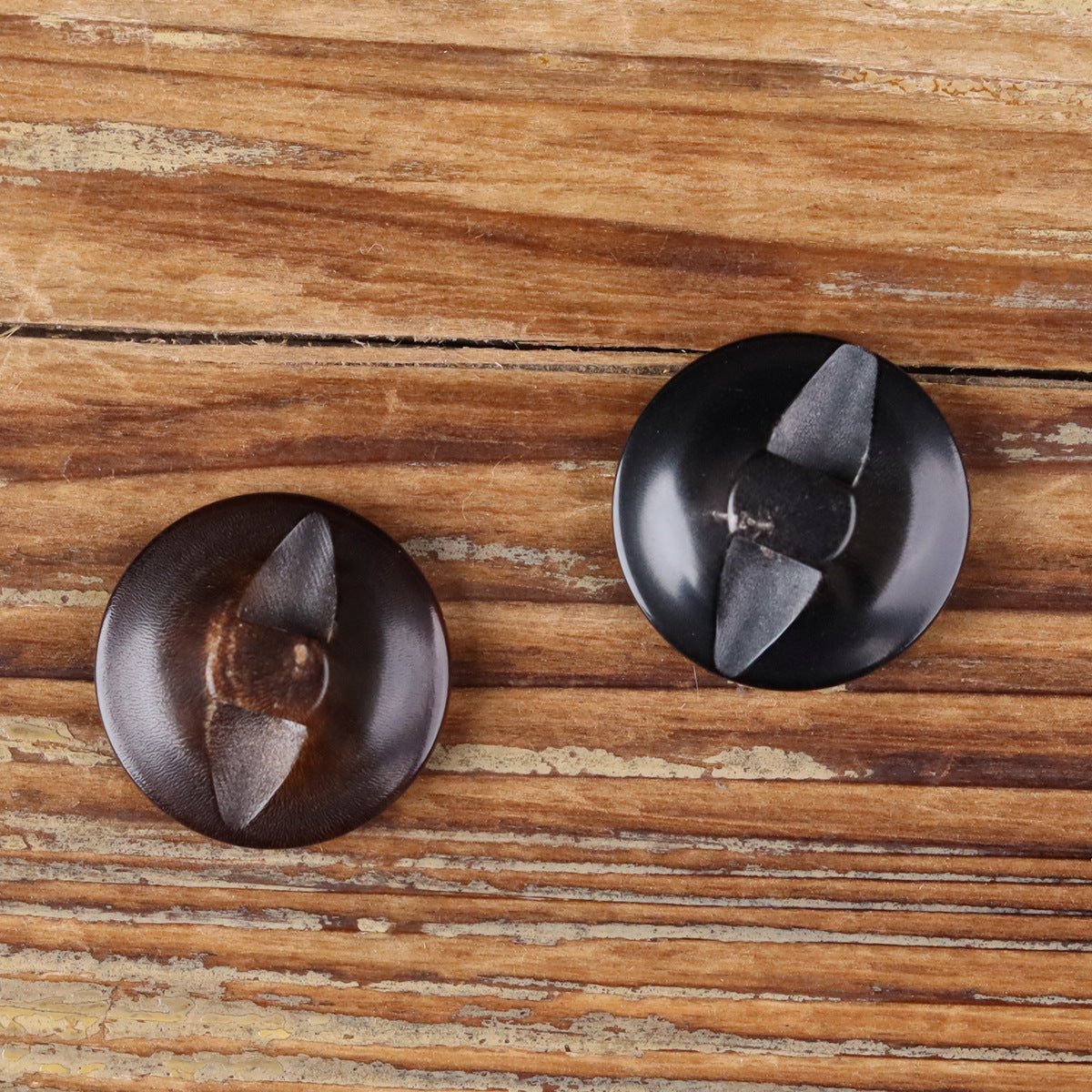 Buffalo horn button backs with hidden eye openings and faceted underside