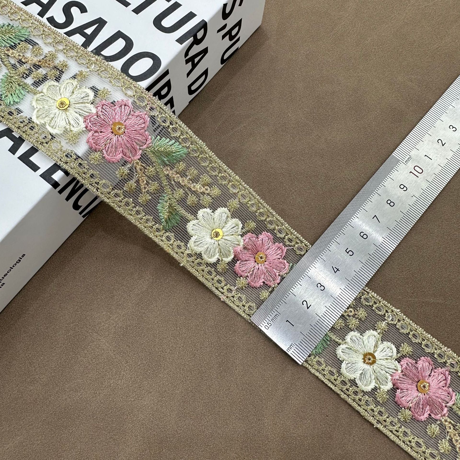 Pink mesh lace trim with embroidered flowers, gold trim edge and light green leaf details