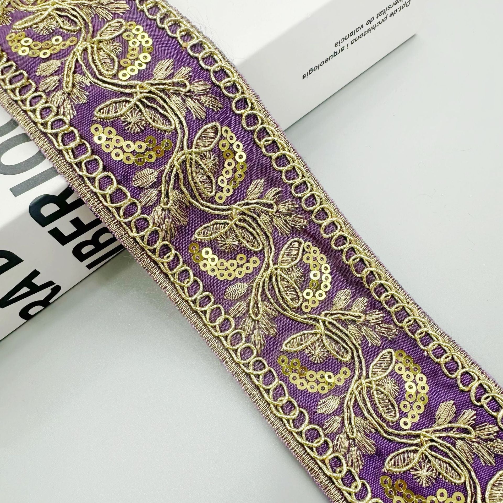 Gold sequin embroidered lace trim ribbon in purple with floral scroll and scalloped edge
