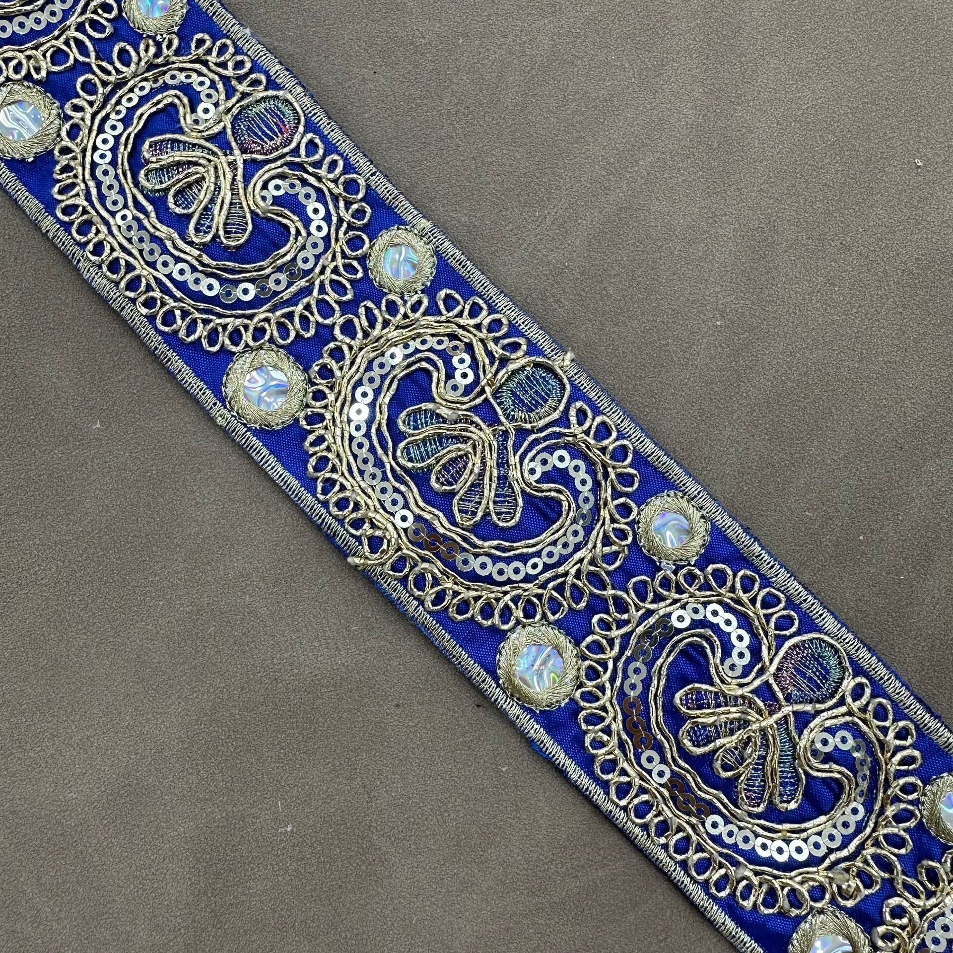 Royal blue embroidered trim with gold-toned paisley motifs and iridescent sequins