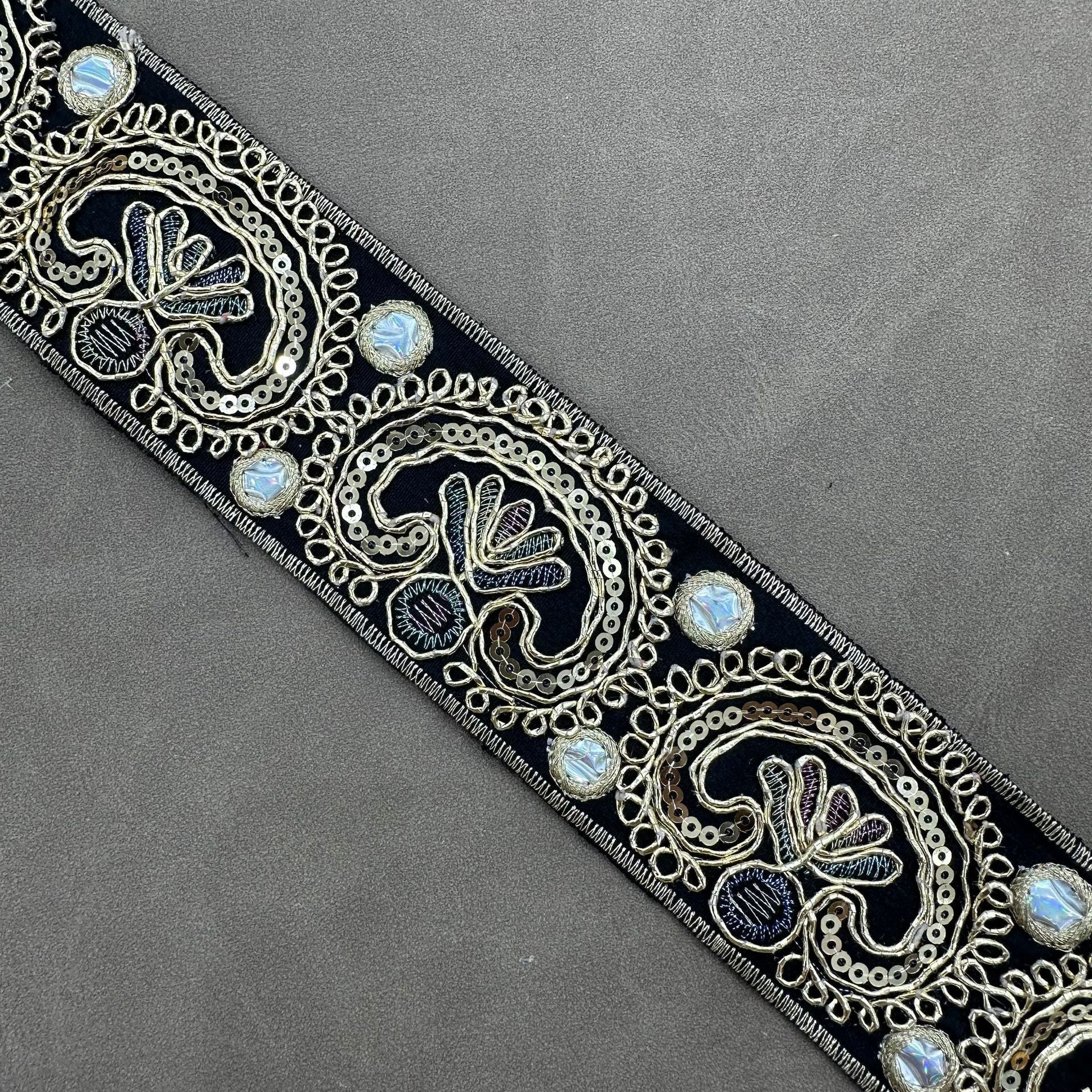 Black embroidered trim with gold-toned paisley motifs and iridescent sequin accents