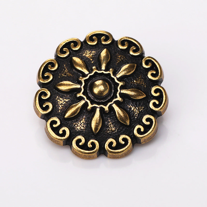 Antique gold domed floral metal shank button close-up of flower and swirls