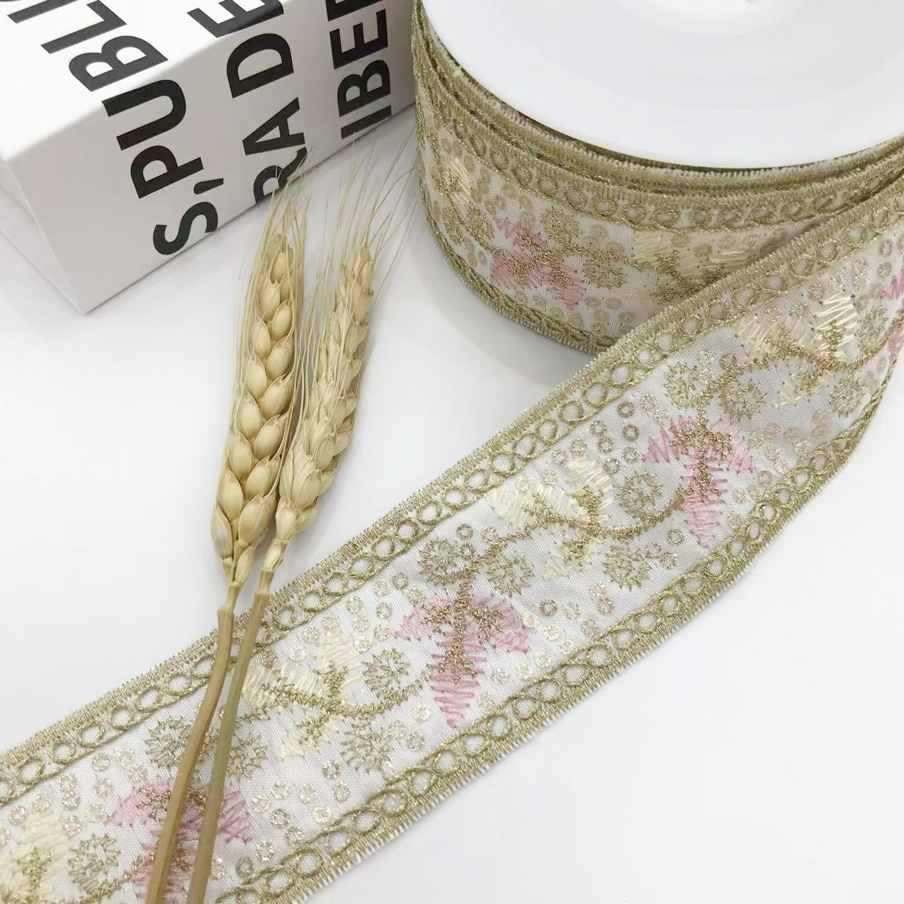 Gold-toned trim ribbon edge with sequin leaf pattern and looped braid, 4.5cm