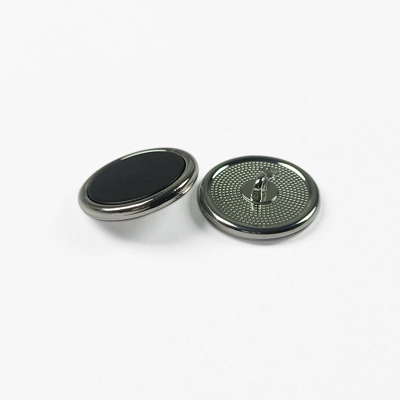 Round metal shank button set, dark metal rim with black face and engraved shank