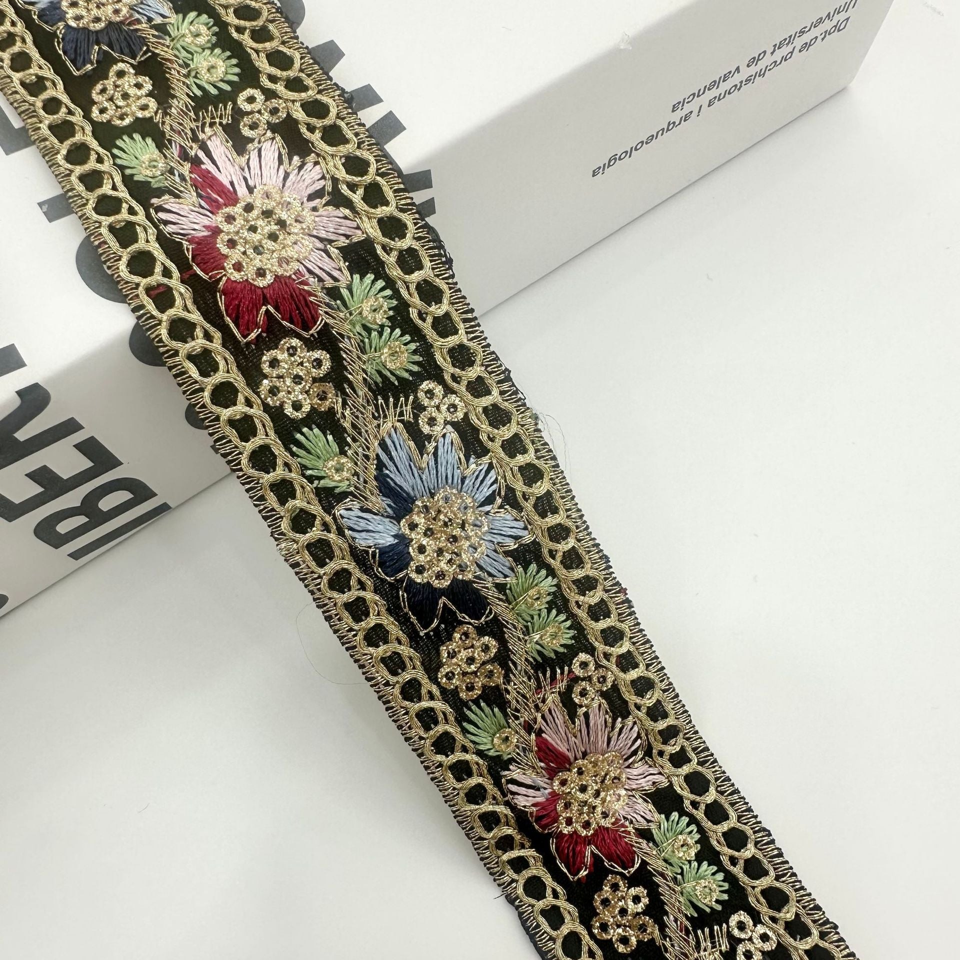 Black embroidered ribbon trim with gold chain edge and multicolor sequined flowers
