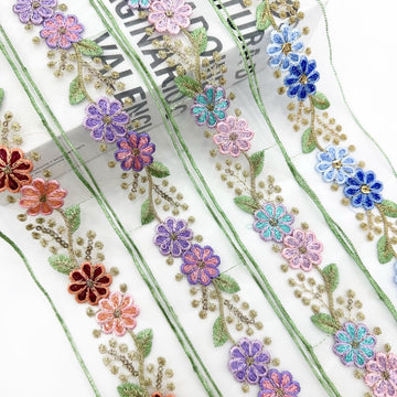 Ethnic organza lace trim with purple, blue flowers and gold thread on pale fabric