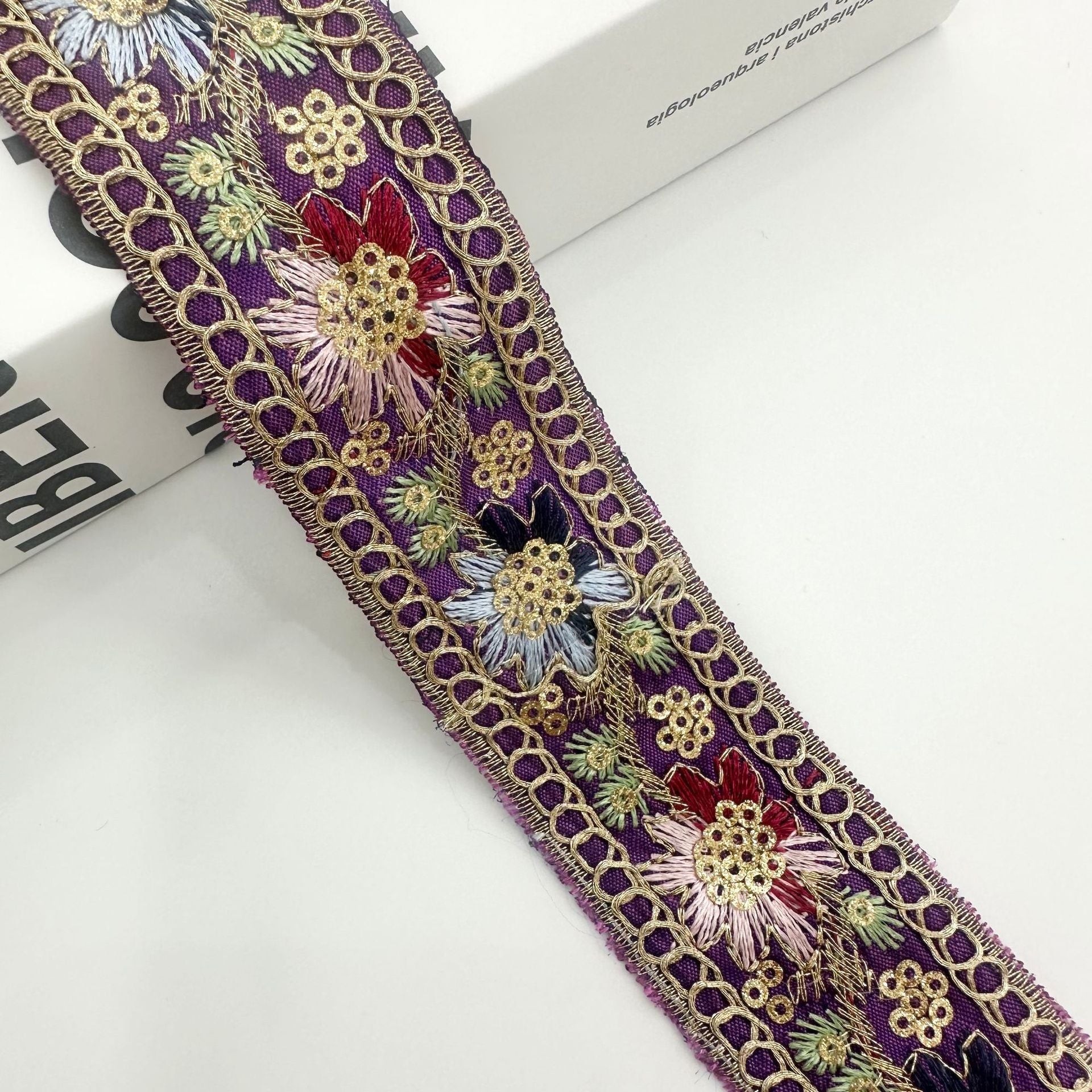 Purple embroidered ribbon trim with gold chain edge and blue and red floral sequin motifs