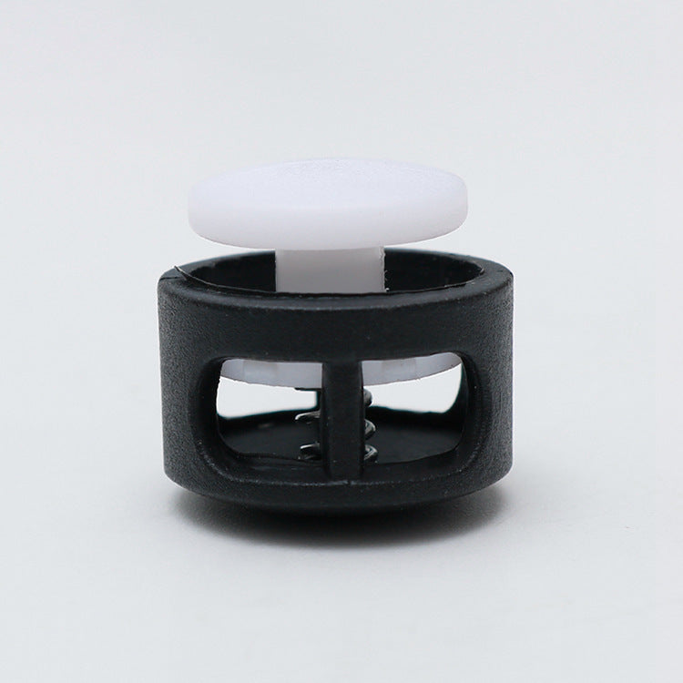 Plastic cord lock toggle with spring, white cap and black housing