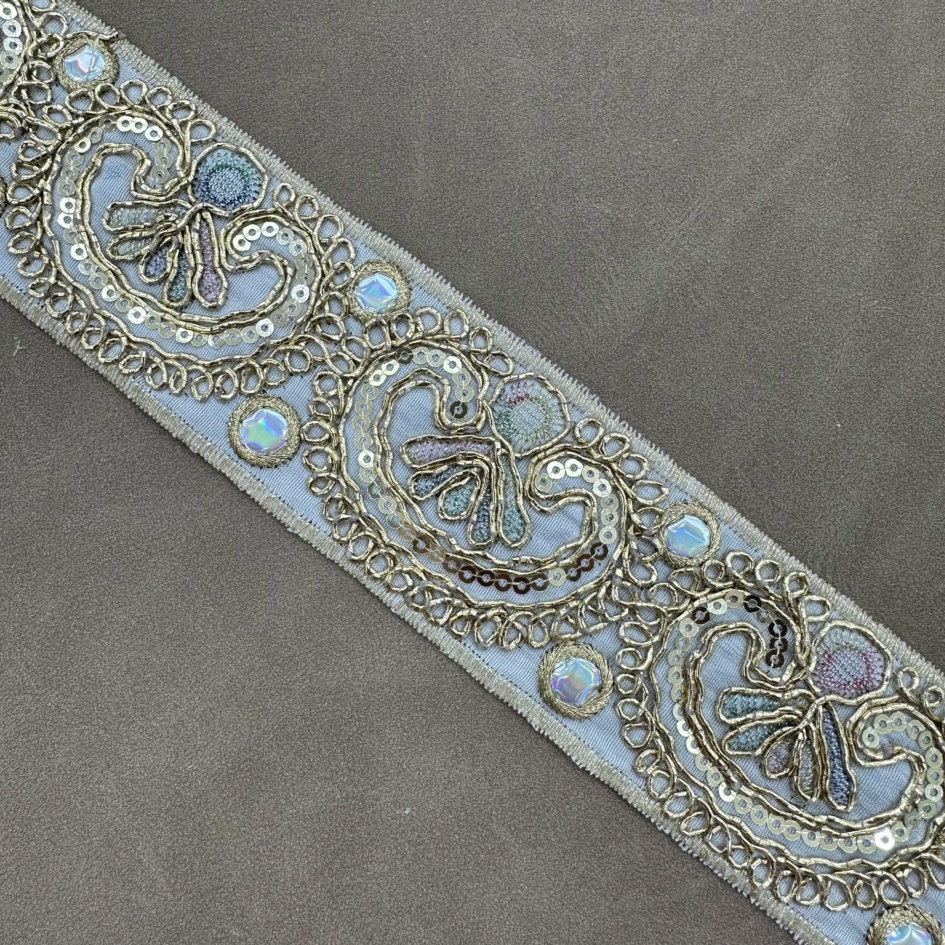 Powder blue embroidered trim with paisley sequin cord motifs and gold edging