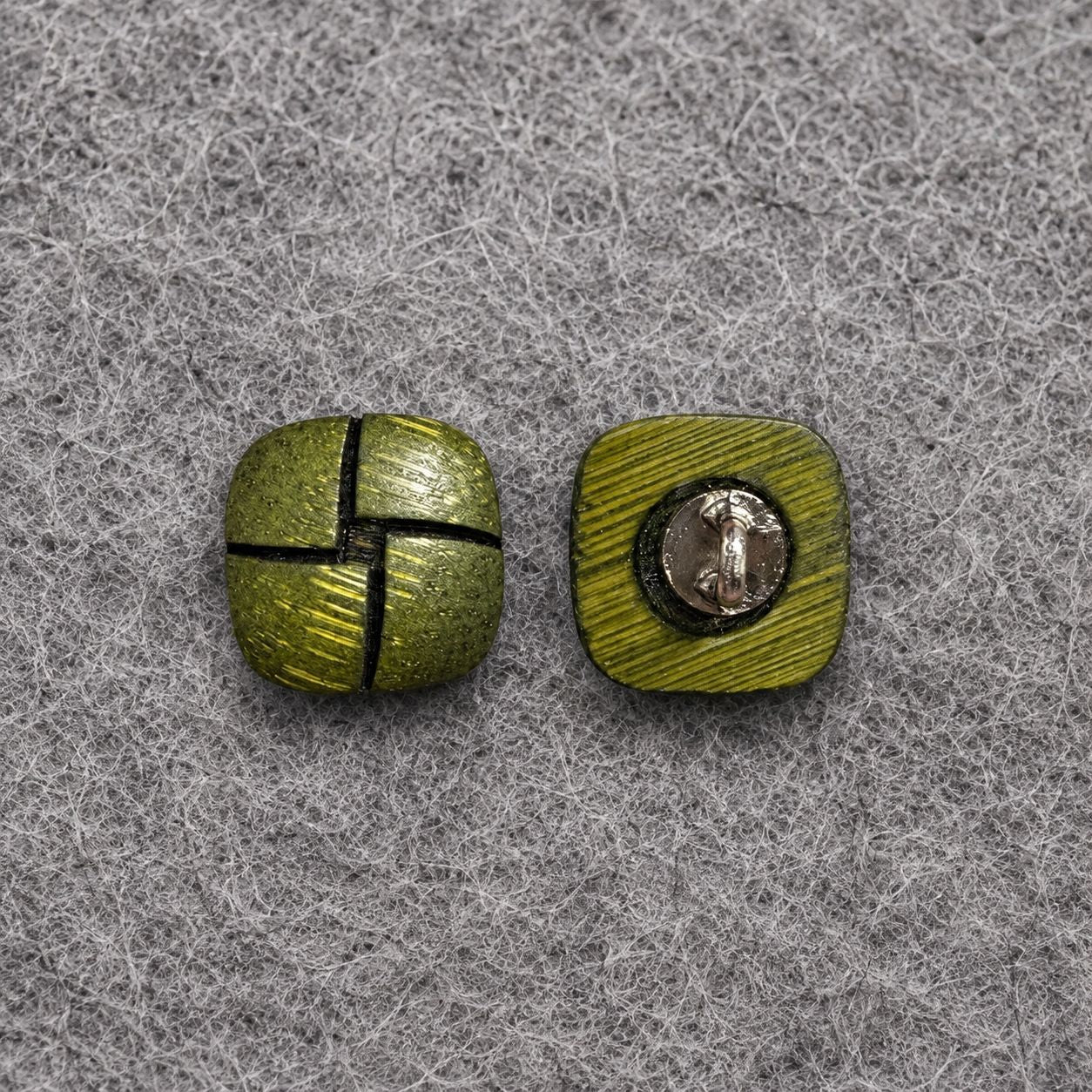 Two green square shank buttons; one shows a metal shank plate