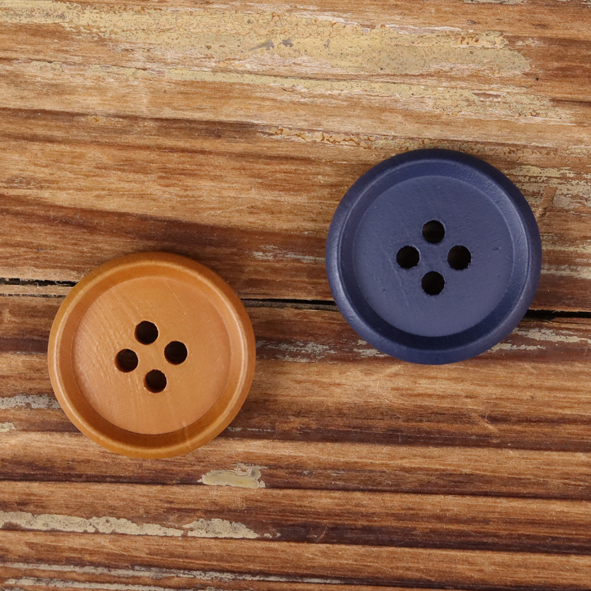 Brown and blue-purple round wood buttons, each with four holes