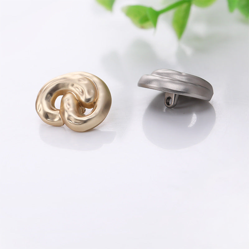 Gold front ear-shaped metal shank button and silver side view with shank