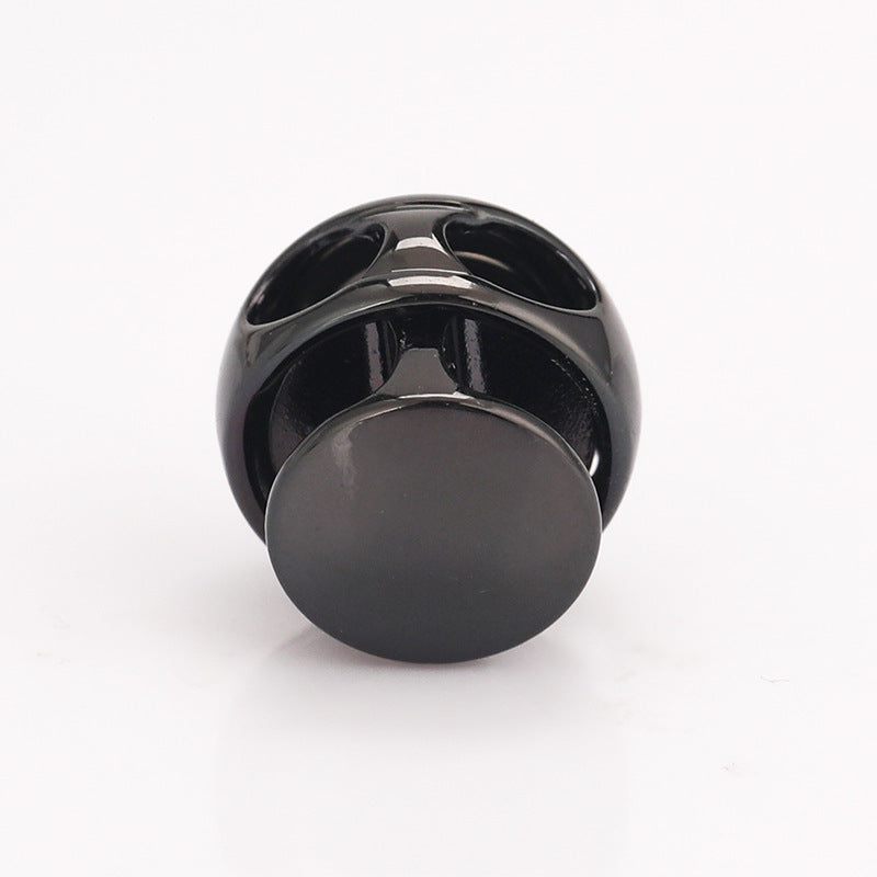 Dark ball-shaped metal spring toggle stopper, rear view with metal spring slots