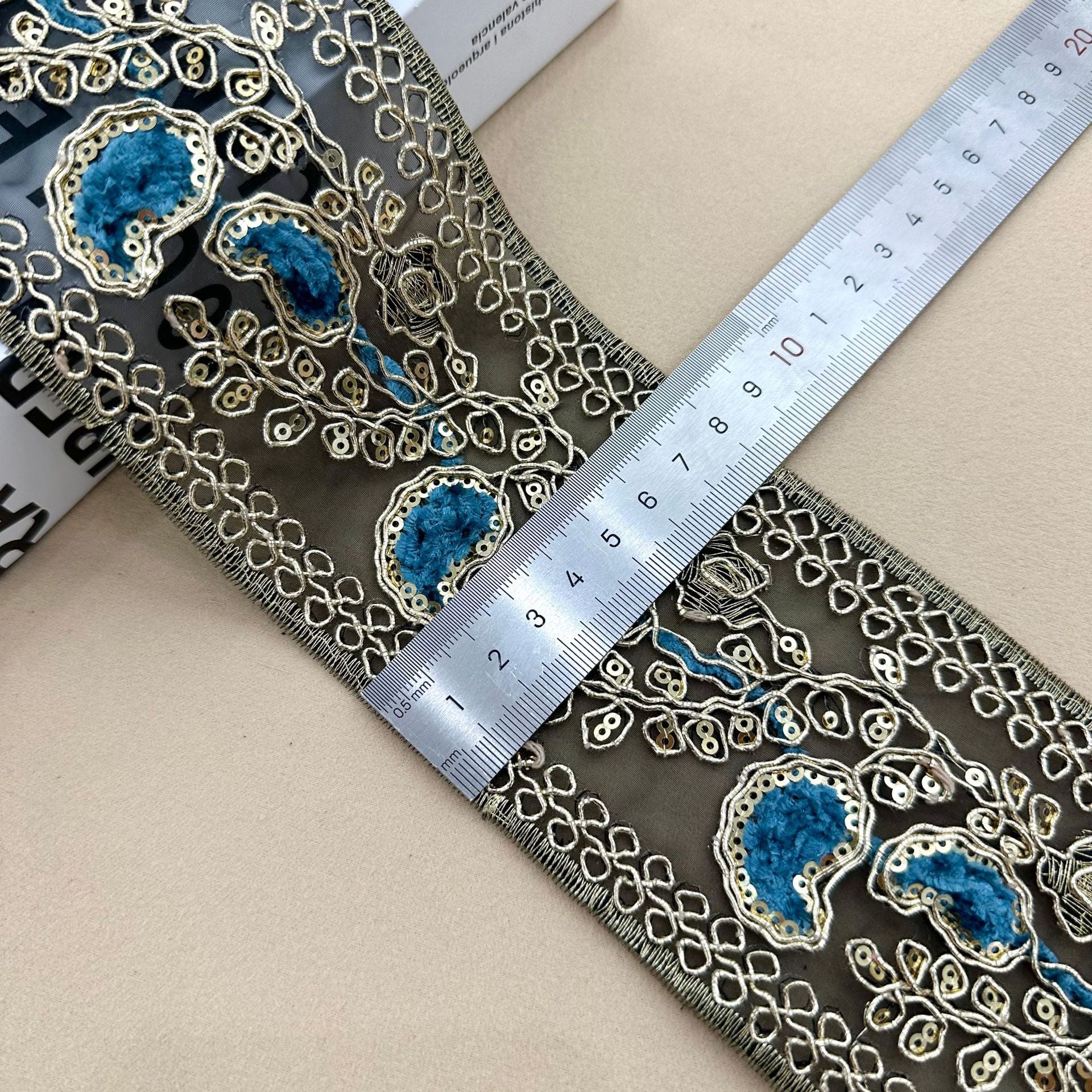 Navy sequin lace trim with blue oval embroidery and looping chain pattern