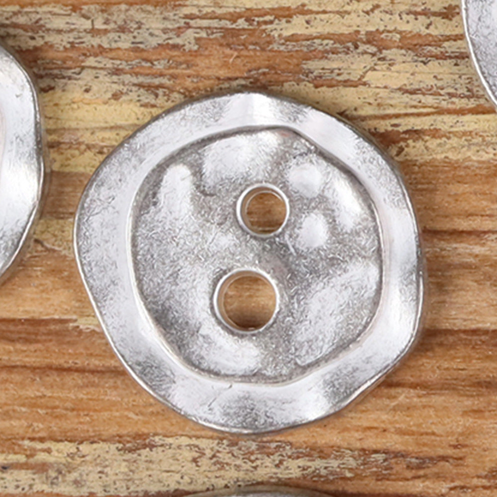 Silver metal 2-hole button, irregular round face with two holes, textured finish.