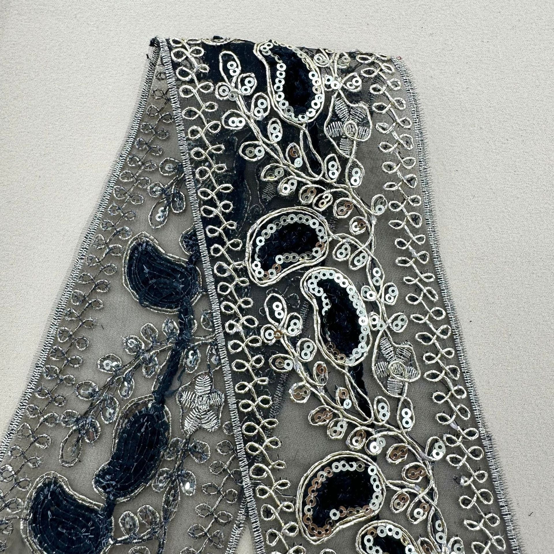 Dark navy sequin lace trim with blue motif appliqués and scalloped sequin outlines