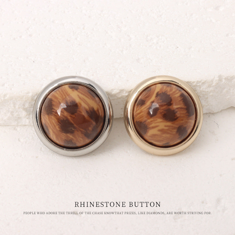 Pair of leopard-print resin mushroom buttons, brown fronts, one silver one gold metal rim