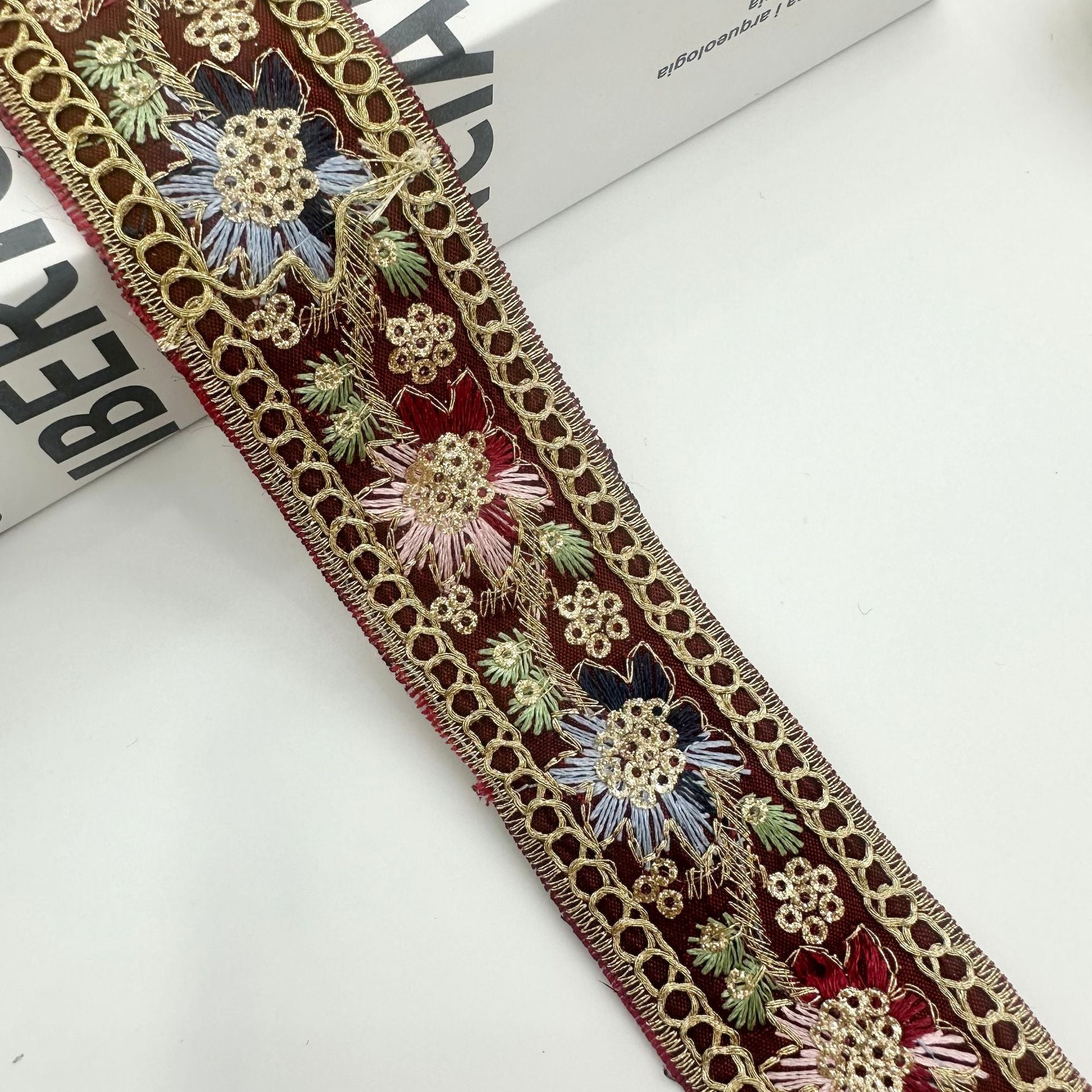 Burgundy embroidered ribbon trim with gold chain edge and blue-red floral sequin motifs