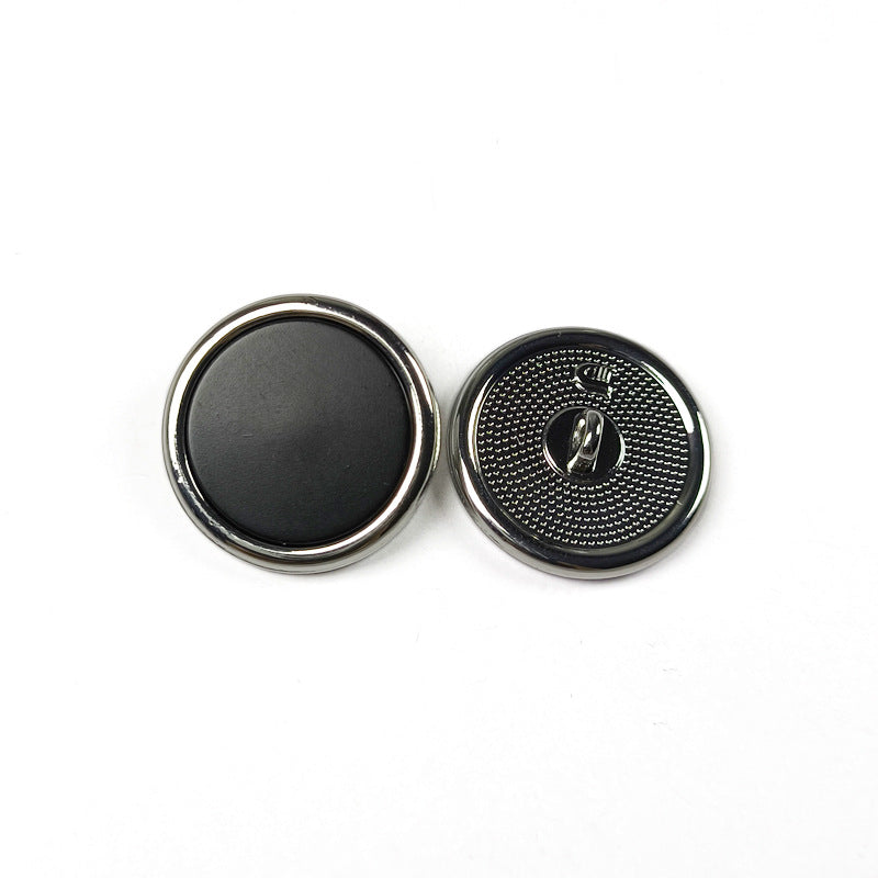 Round metal shank button set, black face with silver rim and engraved shank