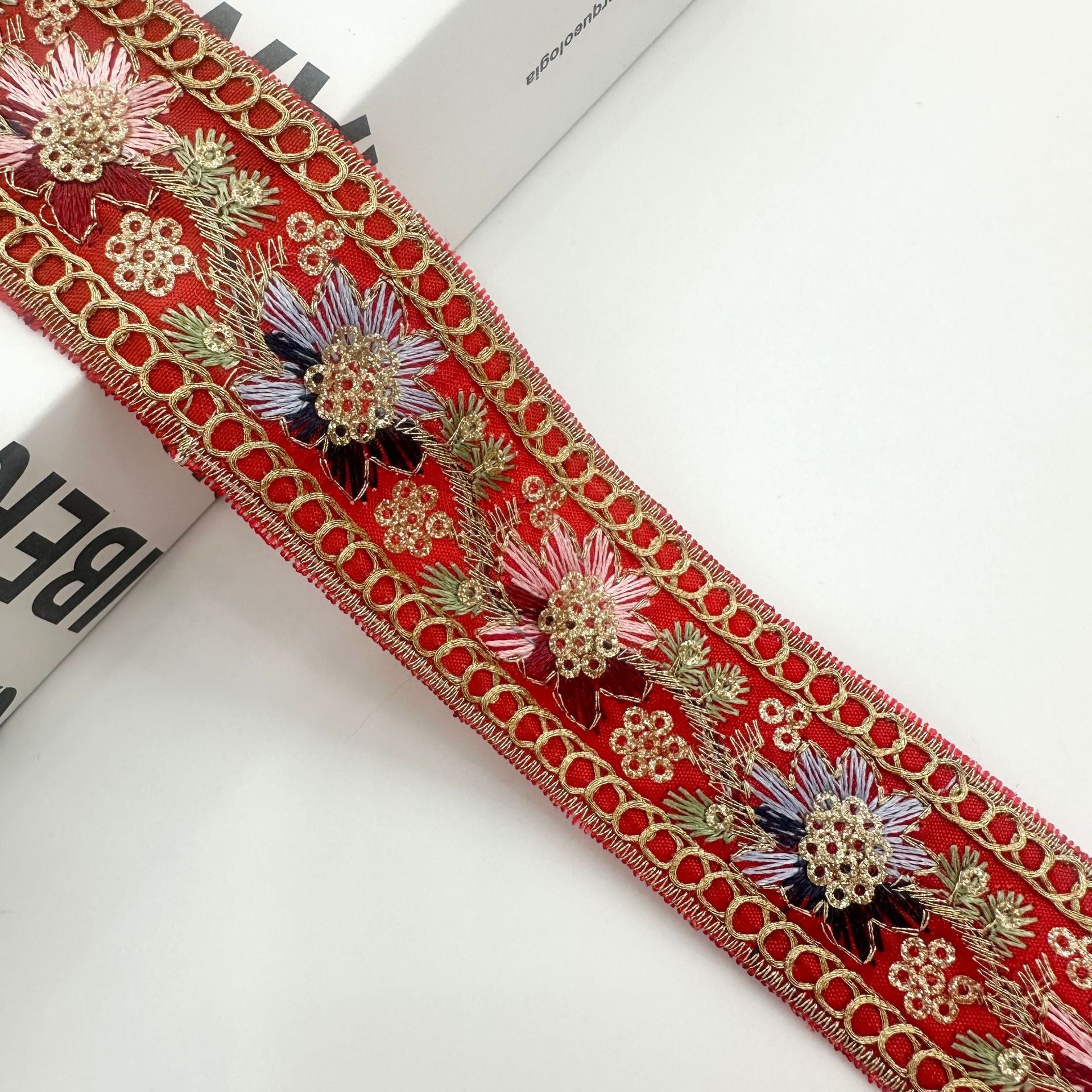 Red vintage ethnic sequin embroidered ribbon trim with gold chain links and floral motifs