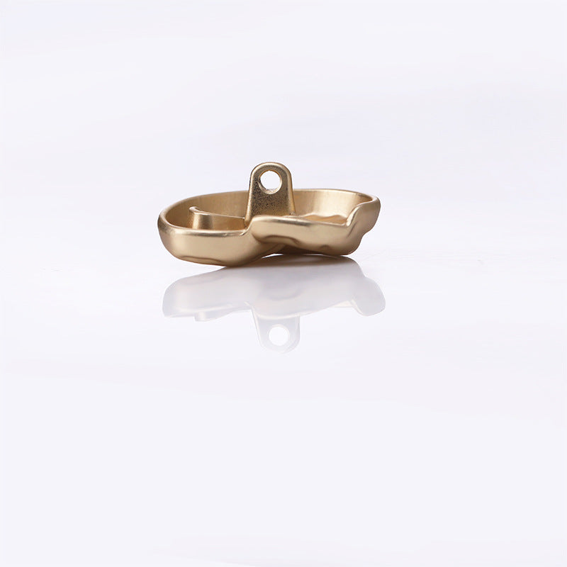 Gold ear-shaped metal shank button, side view showing single attachment hole