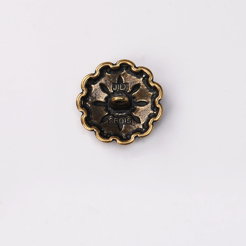 Antique gold domed floral metal shank button underside with markings and shank