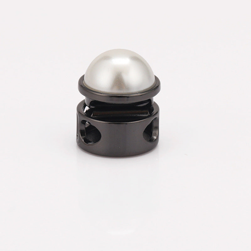 Gunmetal two-hole cord lock with pearl dome top, spring cylinder metal frame