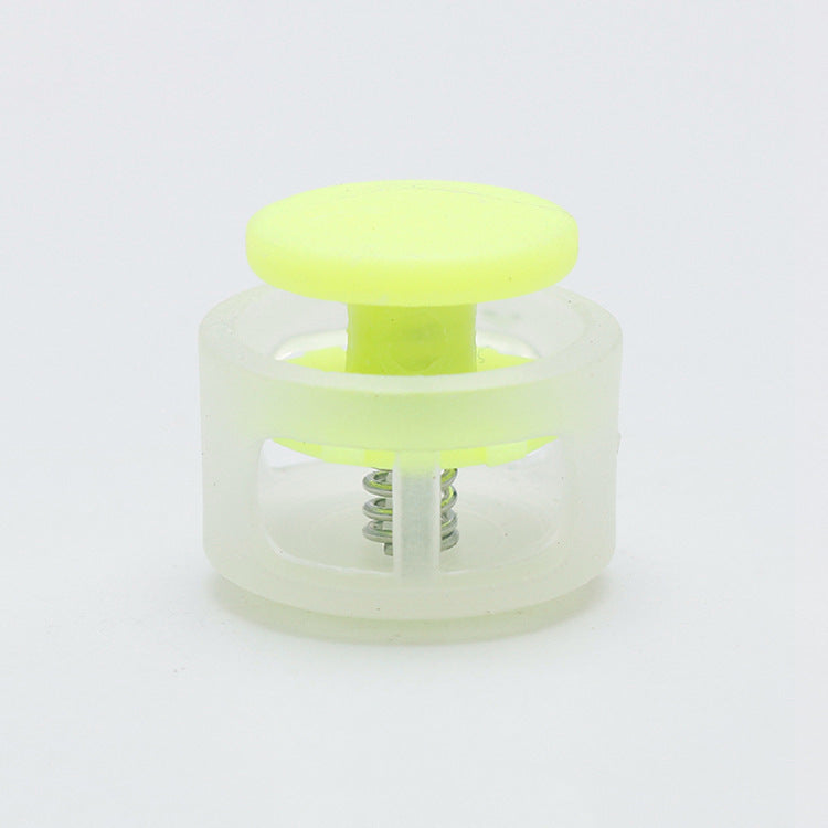 Plastic cord lock toggle with spring, light yellow cap and clear body