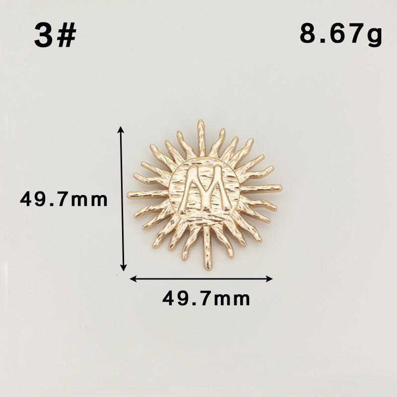 Gold sunburst metal brooch with safety-pin clasp, long rays