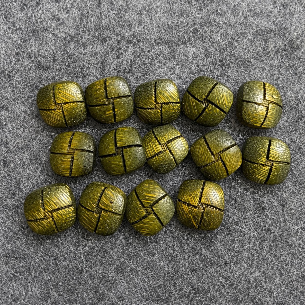 Set of green square shank buttons with cross seam design, woodgrain finish