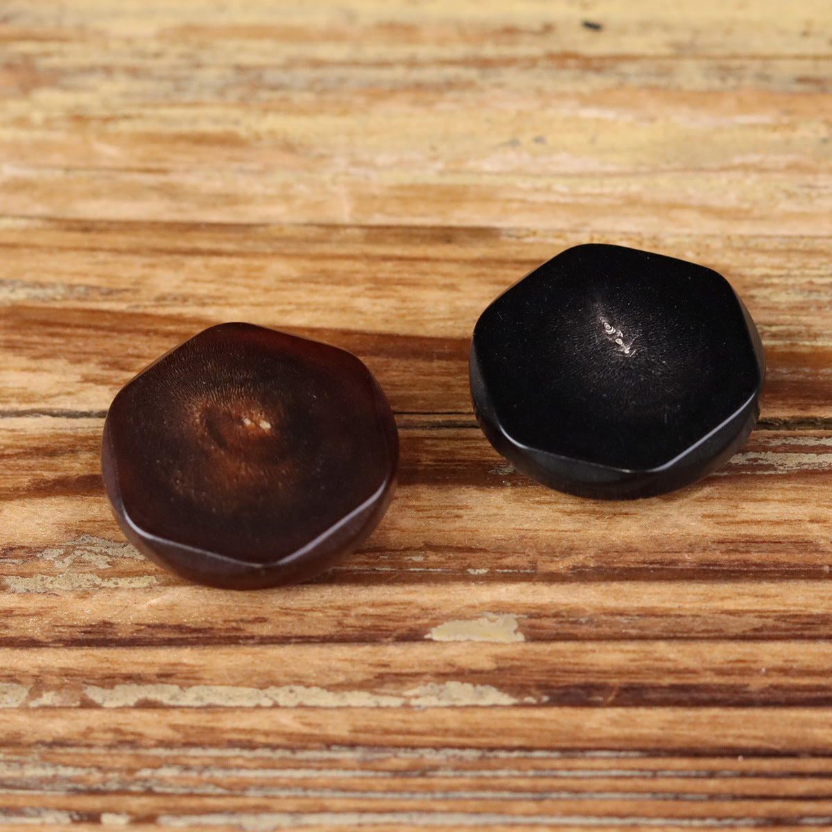 Set of two buffalo horn buttons in dark and dark brown with irregular edges