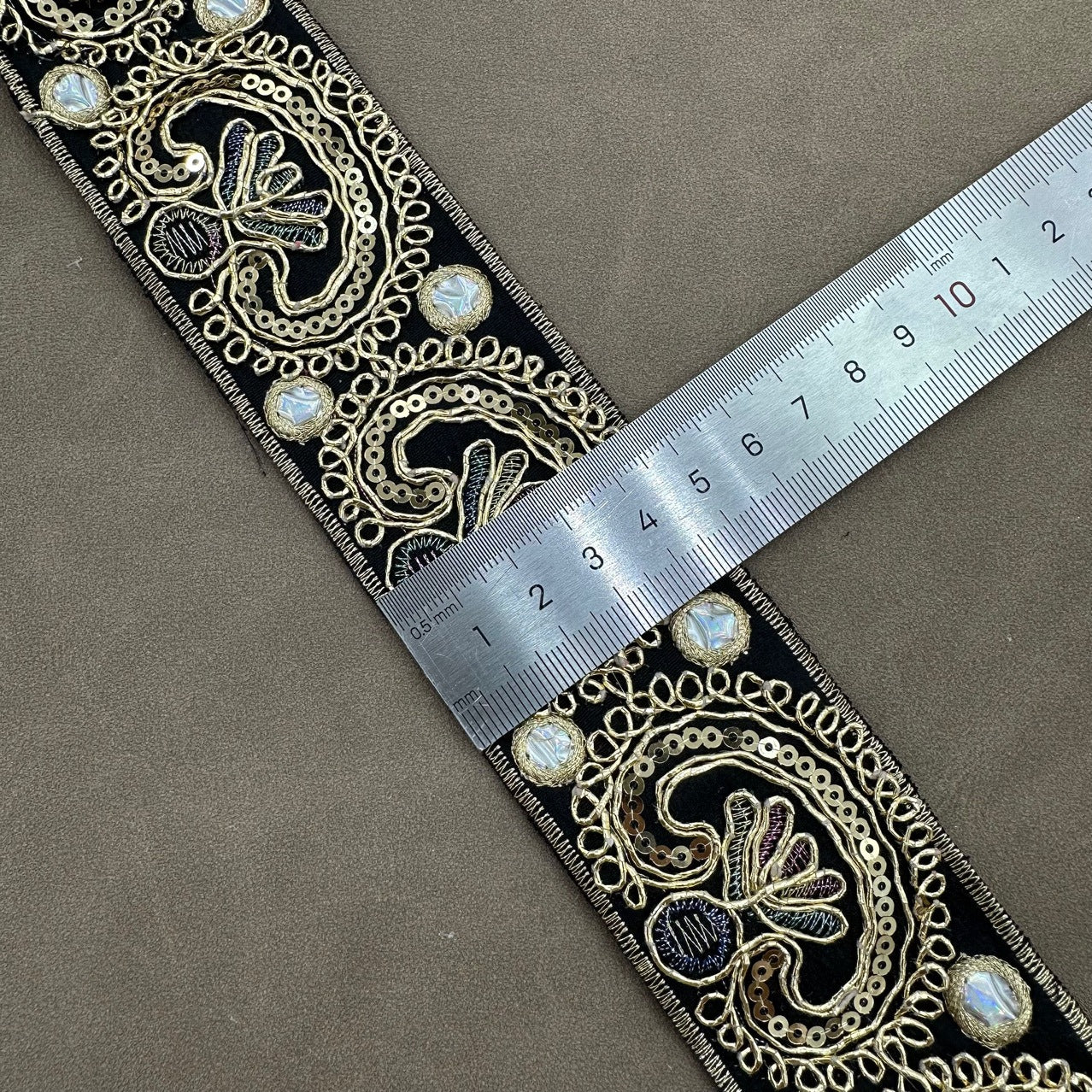 Dark embroidered trim with paisley sequin cord details and gold-toned edging