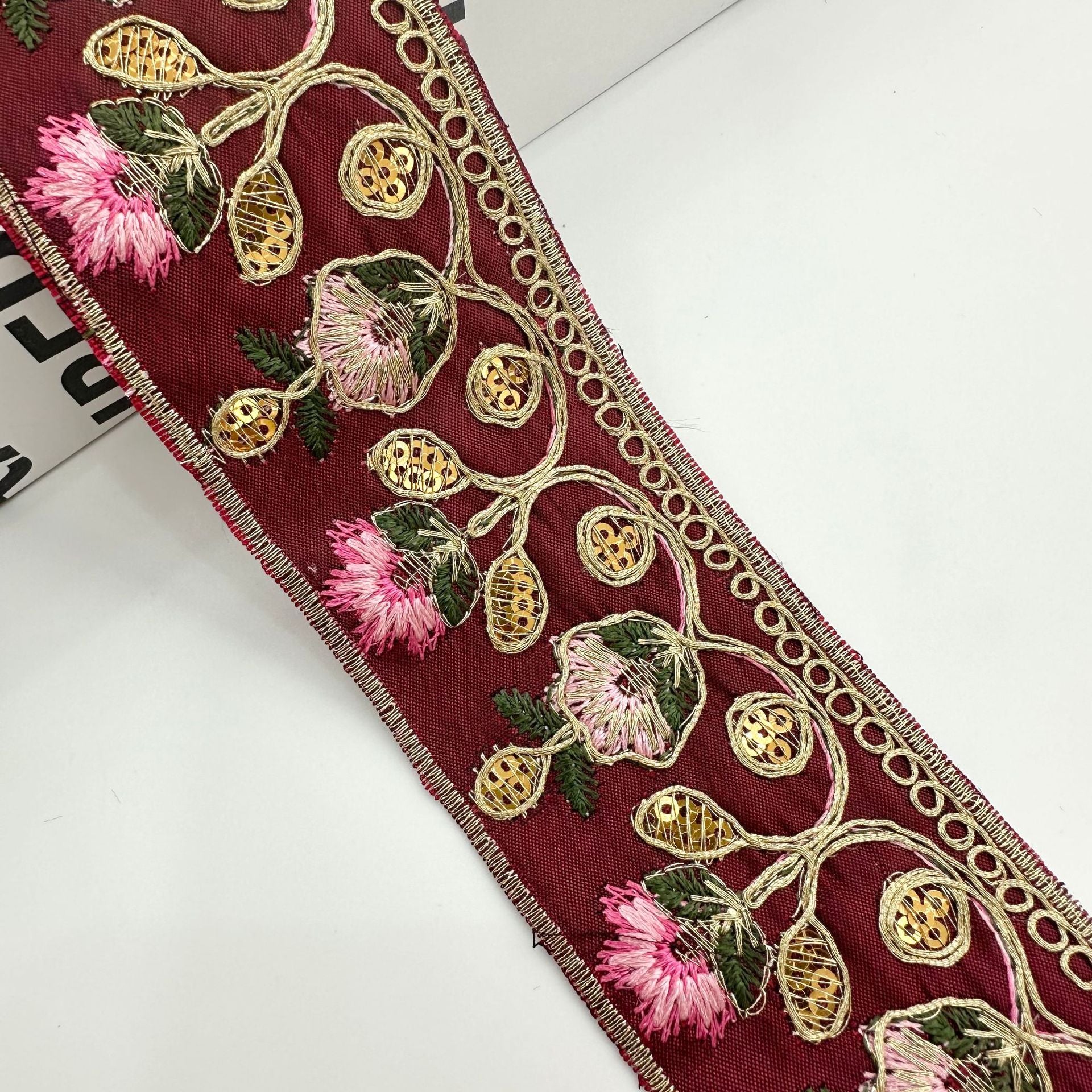 Burgundy embroidered lace trim ribbon with pink flowers and gold oval bead motifs