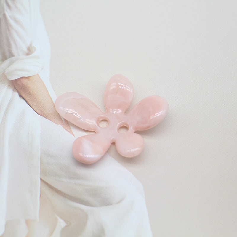 Pink ombré 5-petal resin flower sewing button, two-hole center, glossy petals.