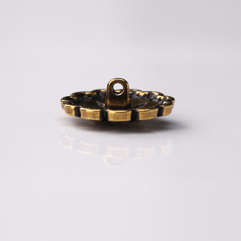 Antique gold metal shank button side view with stitched loop
