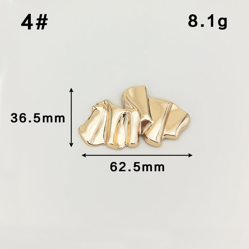 Gold ridged ribbon-like metal brooch with safety-pin clasp