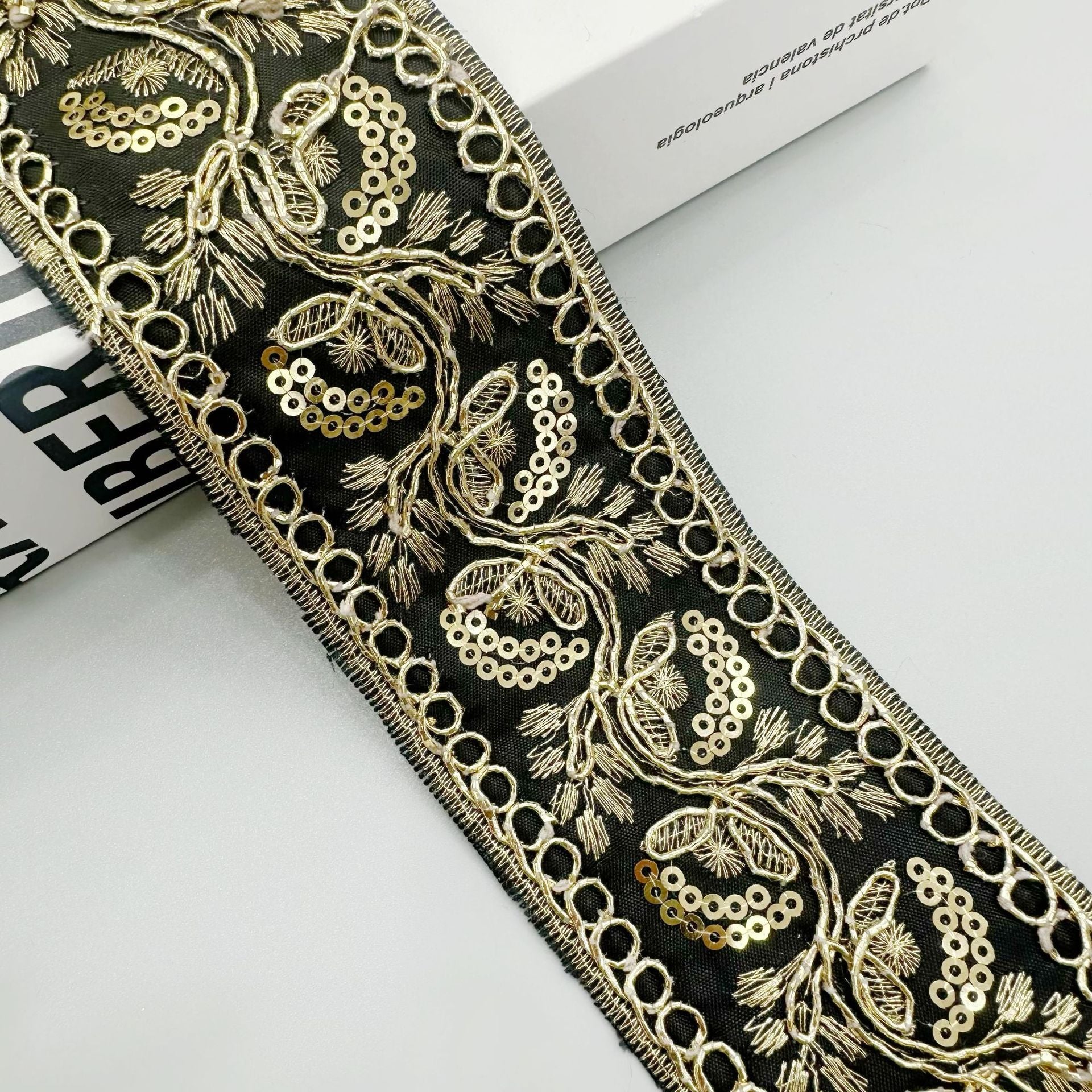 Gold sequin embroidered lace trim ribbon in dark/black with floral scroll and chain border