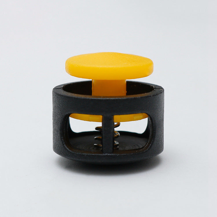 Plastic cord lock toggle with spring, yellow cap and black housing