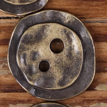 Bronze metal 2-hole button, irregular round face with two holes, textured finish.
