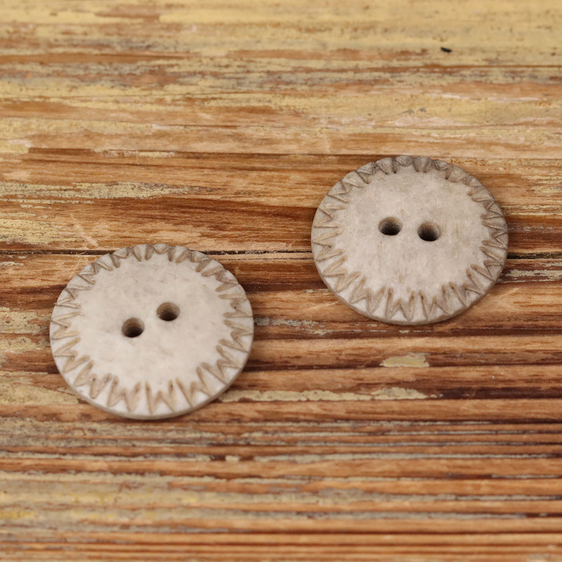 Light khaki natural bone round 2-hole domed button with stitched edge