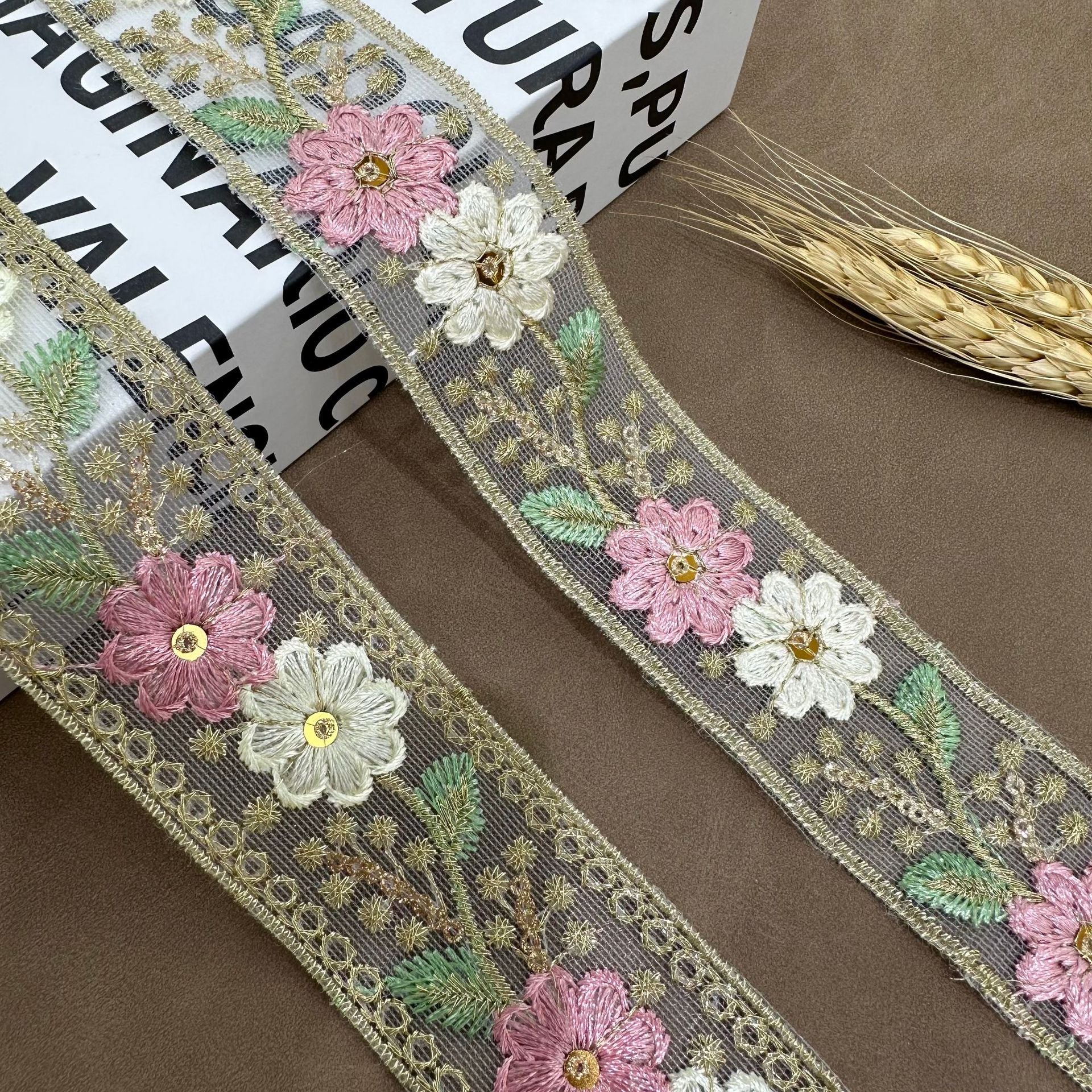 Pink floral mesh lace trim with gold edging; pink and white flowers with green leaf accents