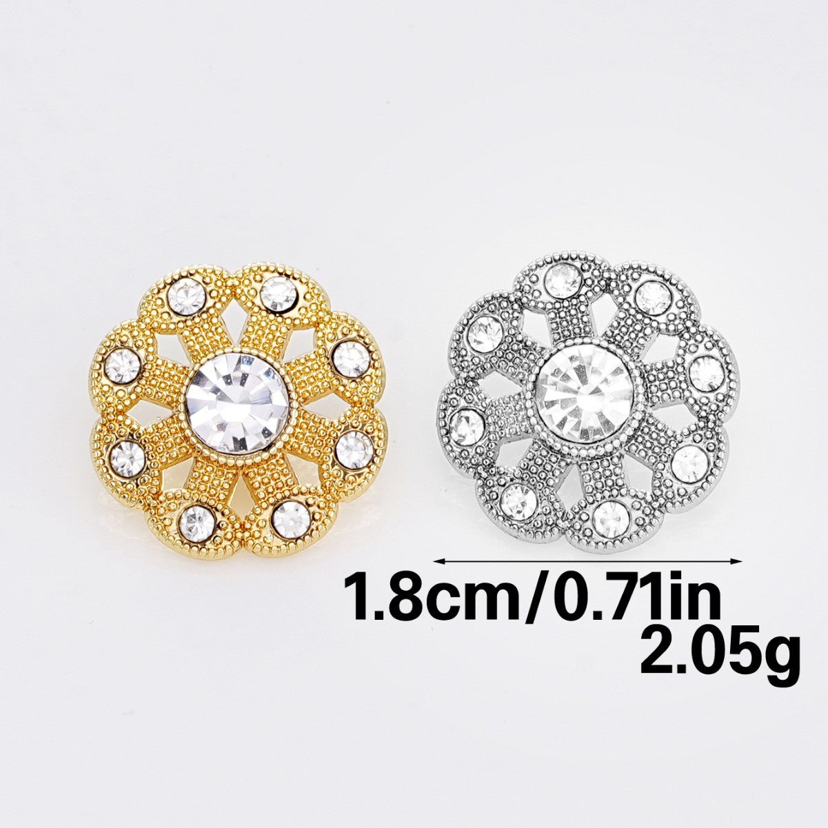 Two rhinestone shank buttons side by side: gold-tone and silver-tone with round center crystals